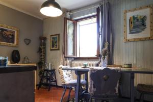 a dining room with a table and a window at Il Nido in Sestola