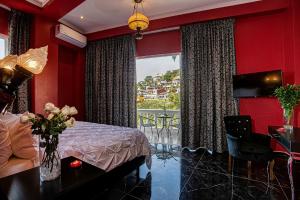 a bedroom with a bed and a table and a window at Hotel Boutique Rivera Del Rio in Puerto Vallarta