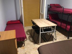 a room with a table and a bunk bed at Euro House in Modena