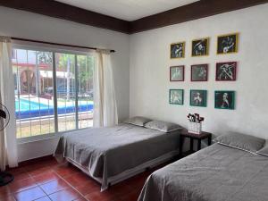 una camera con due letti e una finestra con piscina di Quinta Oaxte a Oaxtepec