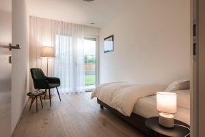 Un ou plusieurs lits dans un hébergement de l'établissement Astor Apartments