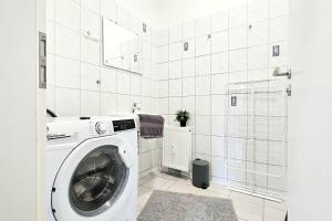a washing machine in a bathroom with a shower at Apartments in Altena in Altena