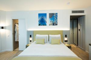 a bedroom with a large white bed with two pillows at Crowne Plaza - Marseille Le Dôme in Marseille