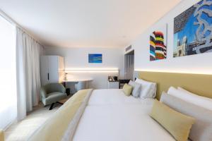 a hotel room with a bed and a desk at Crowne Plaza - Marseille Le Dôme in Marseille