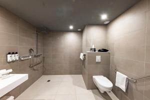 a bathroom with a toilet and a sink at Crowne Plaza - Marseille Le Dôme in Marseille