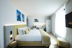 a bedroom with a large bed and a desk at Crowne Plaza - Marseille Le Dôme in Marseille