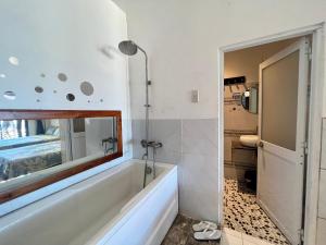 a bathroom with a shower and a mirror at SOHO 1 PHÚ QUỐC in Phu Quoc