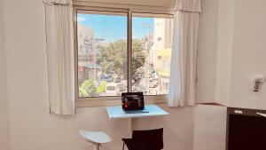 a laptop sitting on a desk in front of a window at Nazarena Studio Apartment in Nazareth