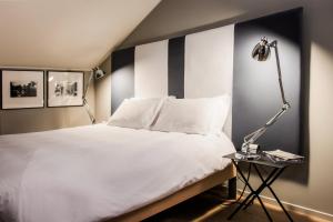 En eller flere senge i et værelse på Hotel Casa Poli
