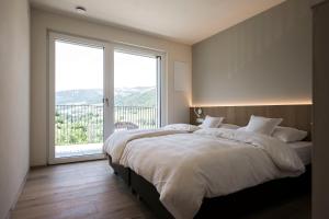 Un ou plusieurs lits dans un hébergement de l'établissement Astor Apartments