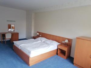 Кровать или кровати в номере Hotel Kaskáda