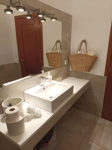 a bathroom with a sink and a mirror at VILLA 21 in Thermisia