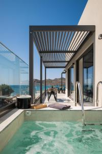 a swimming pool in a house with a view of the ocean at Elia Agia Marina Resort in Agia Marina Nea Kydonias