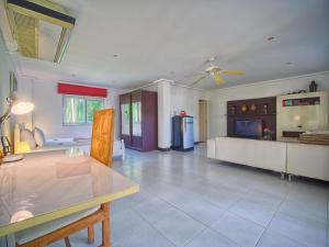 a large living room with a table and a kitchen at Serenity Lakeside Resort in Kathu