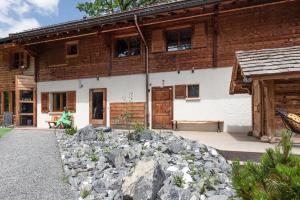 a house with a pile of rocks in front of it at Le Wafo in Gryon