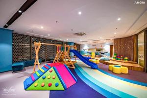 a play room with a slide and a playground at The Song Vung Tau By Abogo in Vung Tau