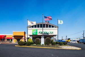a building with two flags on top of it at Holiday Inn South Plainfield-Piscataway, an IHG Hotel in South Plainfield