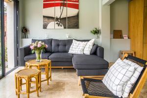a living room with a couch and chairs and a table at Authentique et charmante longère bord de mer in Sainte-Marguerite