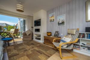 a living room with a couch and a chair at Camber Cottage in Camber