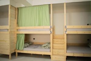 a room with three bunk beds in a room at Hostel Kovači in Sarajevo