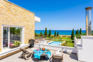 a villa with a view of the ocean at Annabel Beach Palace in Lachi