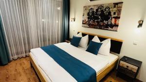 a bedroom with a large bed with blue and white pillows at CHALET-KOPPI in Apetlon