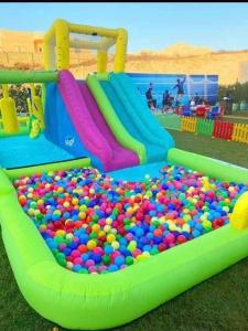 een groot zwembad met ballen in een speeltuin bij صيفك في Grand Hills الكيلو ٦٠ الساحل الشمالي in Abû Zeira