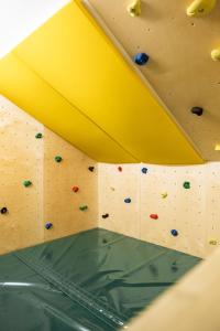 a climbing wall in a gymnasium with boulders at Hotel Lohningerhof in Maria Alm am Steinernen Meer