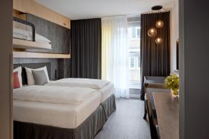 a hotel room with two beds and a window at THE SCOTTY Hotel Hamburg in Hamburg