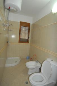a bathroom with a toilet and a bidet at Orikum Veranda Apartments in Orikum +27 photos
