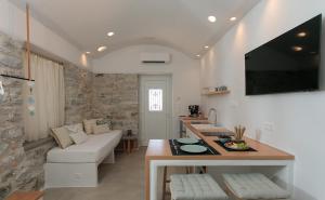 a kitchen and living room with a couch and a table at "Voras Luxury Cave Loft" in Naxos Chora