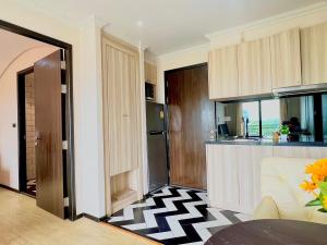 a kitchen with a black and white checkered floor at Venetian river view in Jomtien Beach