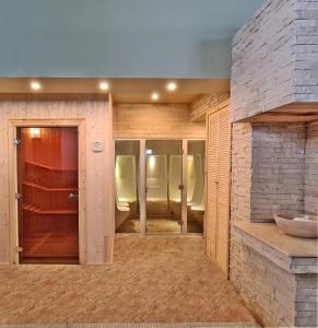 a room with a bathroom with chairs and a door at RIN Airport Hotel in Otopeni