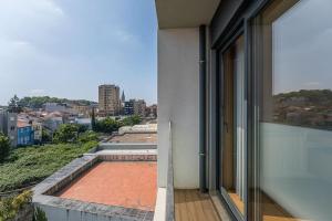 a balcony of a building with a view of a city at GuestReady - A modern retreat in Porto in Porto