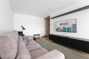 a living room with a couch and a tv at GuestReady - A modern retreat in Porto in Porto