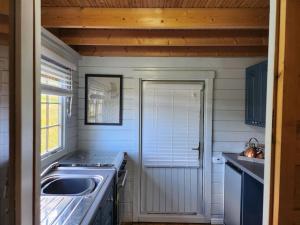 a small kitchen with a sink and a stove at The Meadow in Lapworth