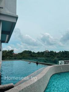 a swimming pool on the roof of a building at Homeseek, Spacious and Cozy Apartment in Kuala Terengganu in Kuala Terengganu
