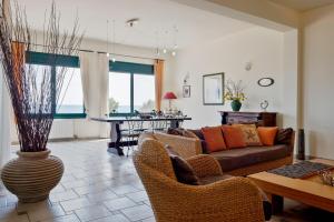 a living room with a couch and a table at Marisia Apartments und Villa in Keratokampos