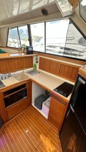 a kitchen on a boat with a counter and a sink at Bateau Vedette 14 mètres in Propriano