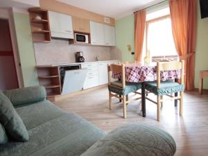 a living room with a table and a kitchen at Modern Holiday Home in Livigno Italy near Ski Area in Livigno