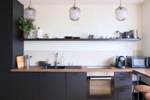 a kitchen with a sink and a counter top at Villa Adèle, Bow-Window vue Mer -Appt 04 in Mers-les-Bains +21 photos
