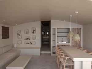 a kitchen and dining room with a long table and chairs at Banwol Poolvilla in Busan