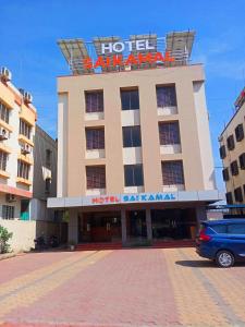 um hotel com uma placa no topo de um edifício em Hotel Sai Kamal em Shirdi