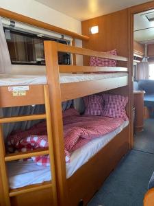 a couple of bunk beds on a boat at ***** Camping Aufenfeld - Sonnenglückhütte in Aschau