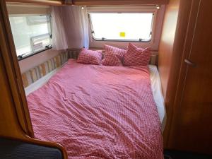 a bed in the middle of a room at ***** Camping Aufenfeld - Sonnenglückhütte in Aschau +9 photos