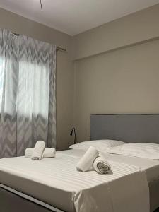 two beds in a bedroom with towels on them at Elaia Apartment in Kavala