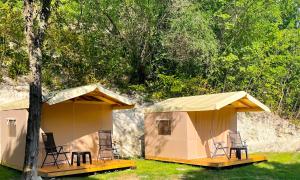 a couple of chairs sitting inside of a tent at Divoto Glamping in Balchik