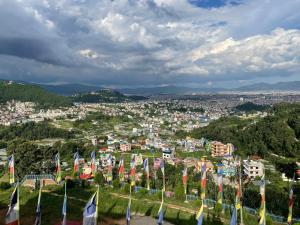 a group of flags on a hill with a city at Season homestay in Kathmandu