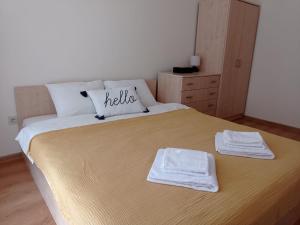 a bedroom with a large bed with two towels on it at LOREA Apartment L000 in Aspen Golf Resort in Razlog