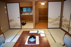 a room with a table with a clock on it at Houshi Onsen Chojukan in Minakami